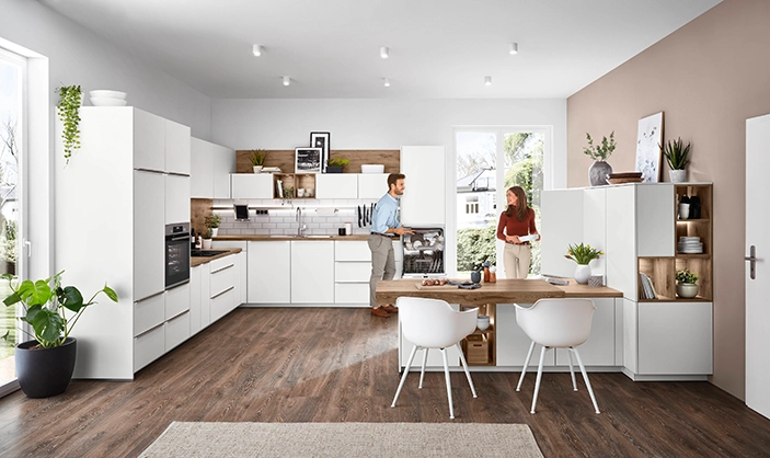 Helle, moderne Wohnküche mit weißen Fronten, Holzakzenten, großem Esstisch und viel Tageslicht. Helle, moderne Wohnküche mit weißen Fronten, Holzakzenten, großem Esstisch und viel Tageslicht.